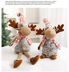 Close-up of reindeer plush dolls with knitted Christmas hats and scarves on a white table