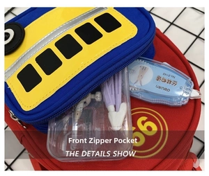 Front zipper pocket of a school bus-style backpack showing stationery storage capacity