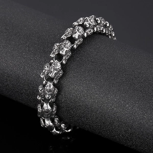 Dettaglio del bracciale punk vintage con teste di lupo e maglie gotiche in acciaio