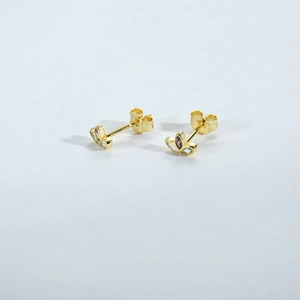 Detailed macro view of S925 silver clover studs with gold coating and marquise cut gems