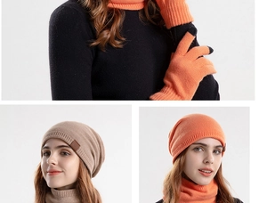 Detail of warm winter knitted set including touchscreen gloves, scarf, and pompom beanie