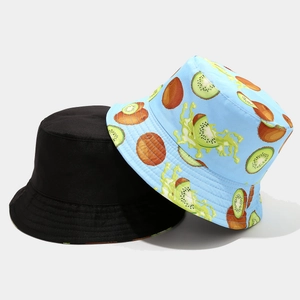 Detail of reversible bucket hat showing vivid kiwi fruit patterns and black cotton canvas