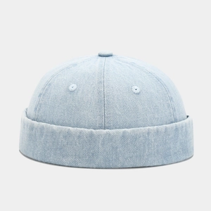 Detailed close-up of light blue denim miki hat with retro washed twill texture and top button