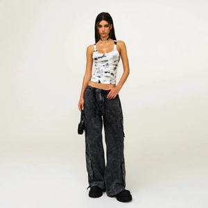 Tie-dye sports vest and gray cargo pants outfit in high-quality studio setting