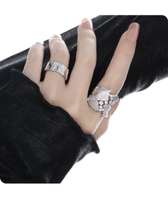 Detailed close-up of S925 silver leaf ring with pavé zircons on a model's hand