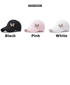 Detailed view of rhinestone butterfly emblems on black, pink and white cotton baseball caps