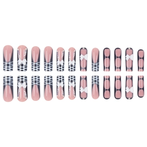 Coffin press-on nails with nude pink base, black grid lines, and 3D white bow charms