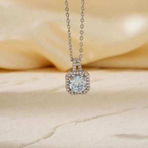 Elegant square zircon pendant necklace with sparkling gems on a beige silk background
