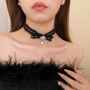 Winter plush black bow necklace with pearl pendant on model for stylish elegant look