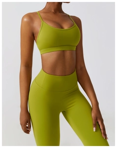Detail of avocado green yoga set featuring high waist leggings and thin strap sports bra