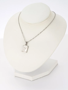 Detail of square shell pendant necklace with letter F engraving on white neck model
