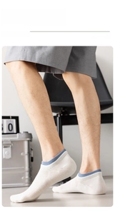 Detail of men's white cotton invisible socks with blue ribbed cuff and knit texture