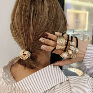 Elegant gold metal knot hair tie and minimalist elastic bands with pearl and charm details