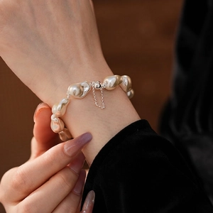 Baroque irregular pearl magnetic bracelet with silver clasp on a model's wrist