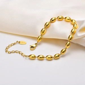 Elegant 18K gold plated oval rugby bead chain bracelet for women on white silk fabric
