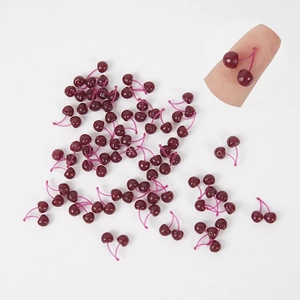Miniature resin cherry charms for DIY crafts and cake decoration on white background