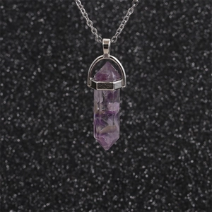 Purple hexagonal crystal column pendant necklace with silver chain on black background