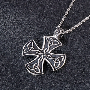 Detailed view of Celtic cross pendant with intricate knot patterns on a twisted chain