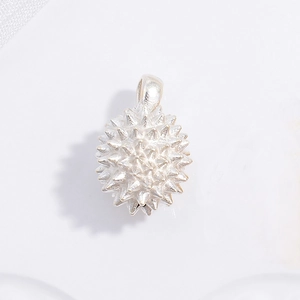Macro shot of silver durian fruit pendant showing realistic spiky texture and details