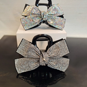 Luxe bow-shaped claw clips with full rhinestones in silver and iridescent colors