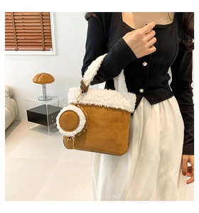 Detail of suede and faux shearling bucket bag with attached round matching coin purse