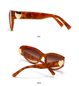 Detail view of tortoiseshell frame sunglasses with heart-shaped gold metal accents