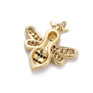 Macro detail of a golden bee charm pendant with intricate hollowed cells for stone setting
