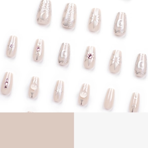 Star and moon themed press-on nails with silver glitter patterns and pink rhinestones