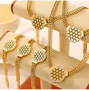 Détail de la parure en titane doré avec pendentif fleur évidé et cristaux brillants