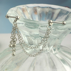 Detail of silver stainless steel industrial barbell featuring double layered hanging chains