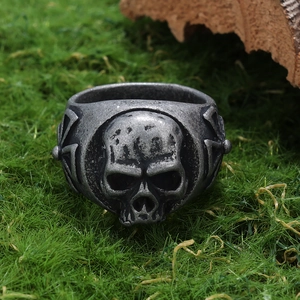 Gothic skull ring in retro stainless steel set on natural moss and wood background