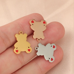 Three mirror polished teddy bear pendants in gold, rose gold and silver with heart detail