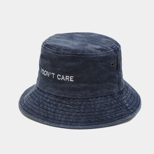 Detail of blue washed denim bucket hat with I DON'T CARE embroidery and metal eyelets