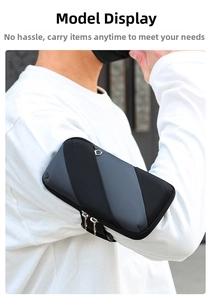 Close-up of sports arm bag with dual zippers and adjustable strap worn on an arm