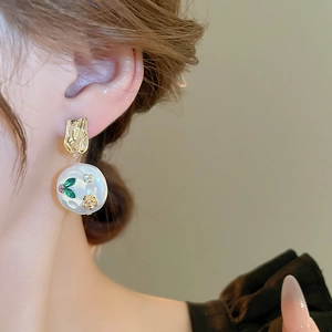 French vintage earrings with gold irregular metal plate, white pearl and green gemstones