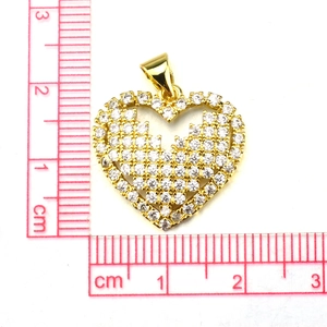 Golden heart pendant with micro-pave zircons shown next to a ruler for size reference