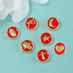Set of 7 gold-plated red enamel bead charms with moon, star, and heart patterns
