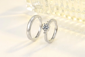 Detail of adjustable couple rings with round moissanite stone and silver texture