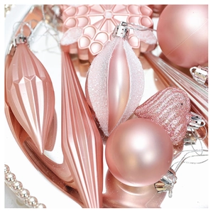 Detail of pink and rose gold Christmas ornaments with glitter and matte finishes