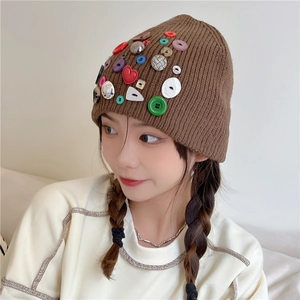 Brown knit beanie with colorful button accents and a stylish slouchy fit for winter