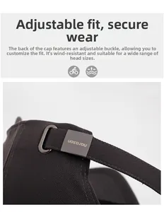 Detail of adjustable metal buckle and canvas strap on a grey outdoor baseball cap