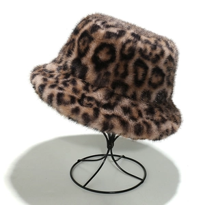 Detail of plush faux fur leopard print bucket hat with thick warm texture on stand