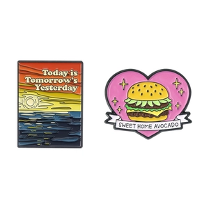Cartoon burger and sunset enamel pins with creative typography on a white background