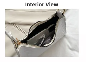 Interior display of white crocodile pattern baguette bag showing daily essentials storage