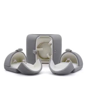 Three-piece grey velvet jewelry box set with necklace slot and ring holders on white background