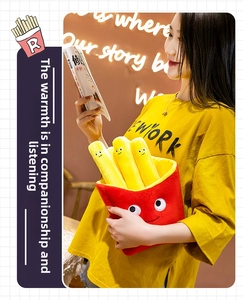Close-up of soft plush French fries toy with cute facial embroidery held by a model