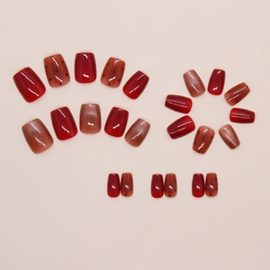 Detail of red cat eye and polka dot press-on nails with velvet finish in short square shape
