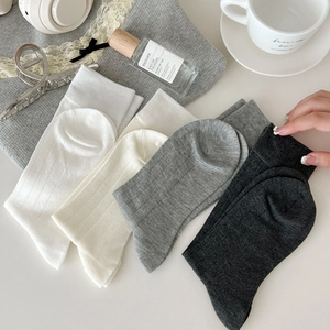 Set of minimalist mid-calf cotton socks in white, beige, and grey neutral tones