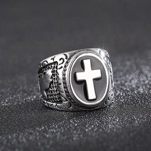 Retro stainless steel cross ring with prayer hands relief in a vintage silver finish