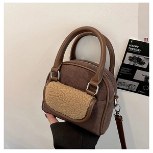 Detail of plush faux fur texture and brown matte leather on the vintage shoulder bag